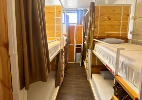 a hallway with bunk beds in a small room at The Hostel Santiago in Santiago