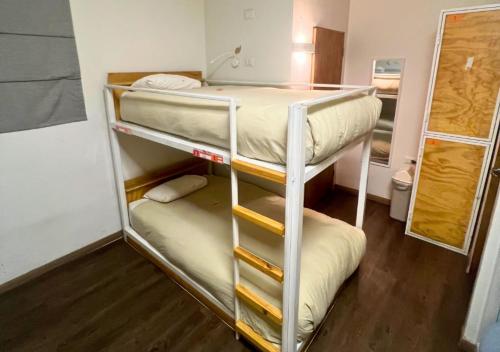 a room with two bunk beds in a room at The Hostel Santiago in Santiago