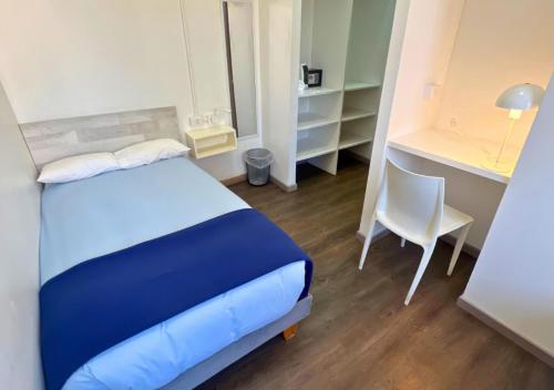 a bedroom with a bed and a desk and a chair at The Hostel Santiago in Santiago