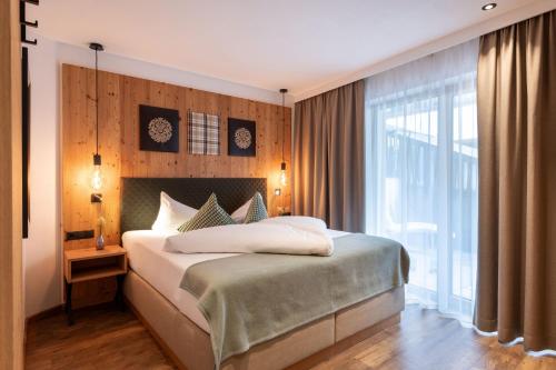 Ein Bett oder Betten in einem Zimmer der Unterkunft Appartements ALMA