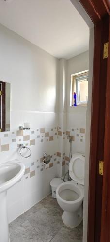 a bathroom with a toilet and a sink at Perfect palm Condos-Kings Sapphire in Nakuru