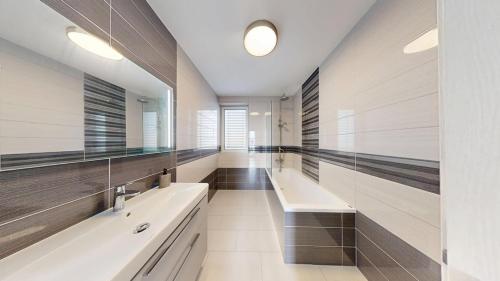 a large bathroom with two sinks and two mirrors at Exkluzívny rodinný dom Trnava - rodiny, pracovné cesty in Trnava