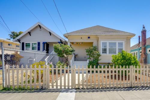 a house with a wooden fence in front of it at 1 Mi to Dimond District Oakland Home with Deck in Canyon