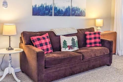 a brown couch with two pillows on it in a living room at Cozy Ludlow Escape in Ludlow