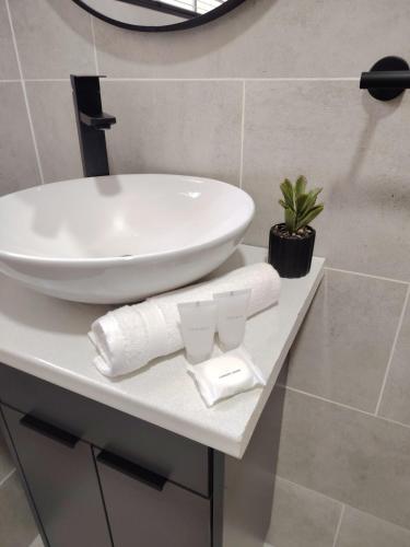 a bathroom with a sink and towels on a counter at F'leur Guesthouse in Mokopane