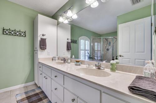 a bathroom with two sinks and a large mirror at Dog-Friendly Home, Lake Henderson Across Street! in Inverness