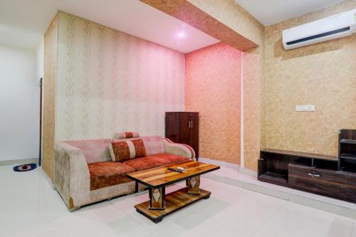 a living room with a couch and a table at HOTEL O YASH RAJ PALACE in Rāe Bareli