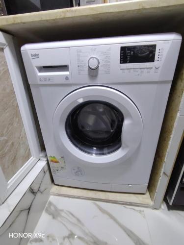 a white washing machine sitting in a room at بيت الطبيعة nature house in Jerash