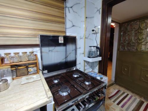 a kitchen with a stove top oven in a room at بيت الطبيعة nature house in Jerash