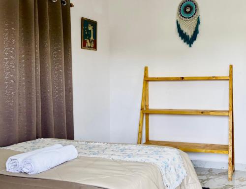 a bedroom with a bed and a wooden shelf at Serendipity Goa - Apartments and Cafe in Arambol