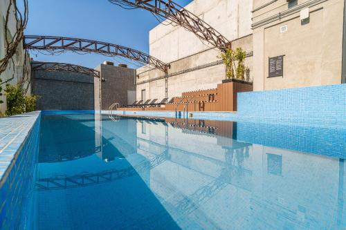 a large swimming pool with blue water in a building at Stylish Studio w Gym & Pool Access VIATO HOMES in Mexico City