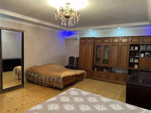 a bedroom with two beds and a mirror and a chandelier at Guest Hause Lile in Tsʼageri