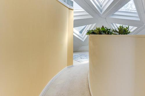 a hallway with a white ceiling with plants at Walk to School House Winery Home with Deck! in Dover