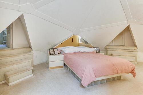 a bedroom with a bed in a attic at Walk to School House Winery Home with Deck! in Dover