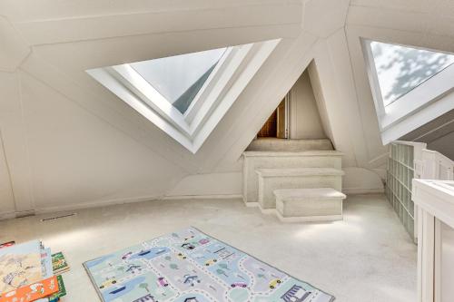 a attic room with a skylight and a rug at Walk to School House Winery Home with Deck! in Dover