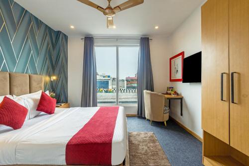 a hotel room with a large bed and a window at Hotel Lexus in New Delhi
