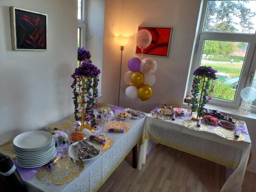 a table with a bunch of food and balloons at Big House Near Beach & Lake in Haderslev