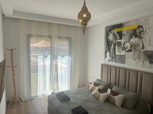 a bedroom with a bed and a large window at ART NORIA Private garden - pool view in Marrakech