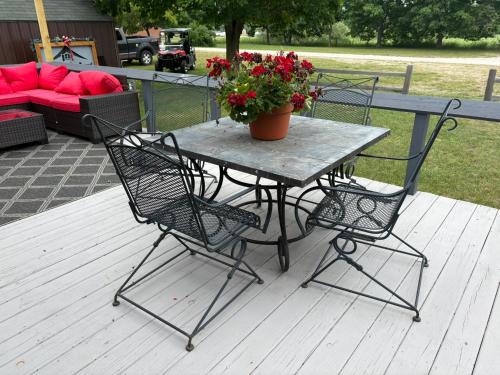 a table and chairs with a potted plant on a deck at Pleasant Valley Resort in Arcadia