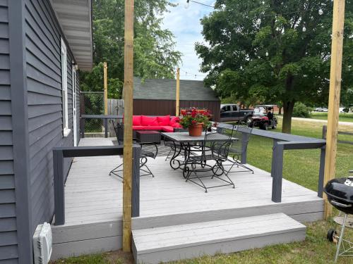 a wooden deck with a table and chairs on it at Pleasant Valley Resort in Arcadia