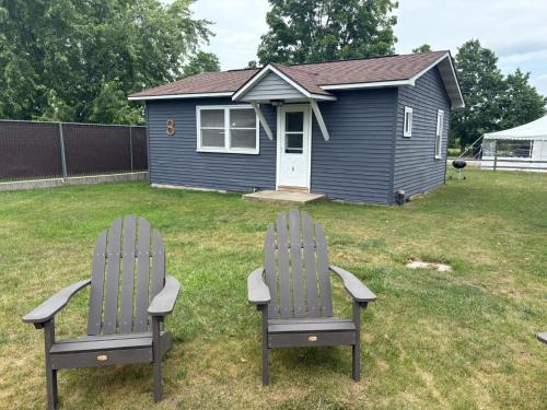 two chairs sitting in a yard in front of a house at Pleasant Valley Resort in Arcadia