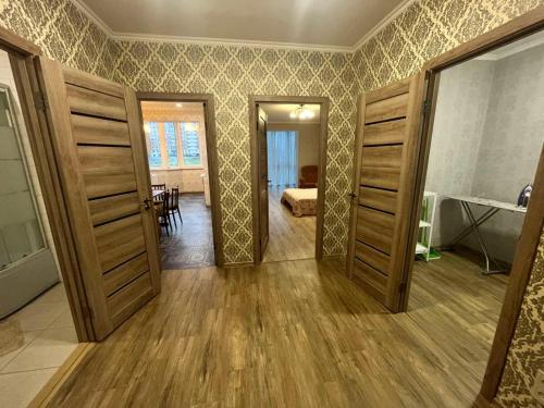 a room with two open doors and a living room at Апартаменты у моря 60м2 in Kryzhanivka