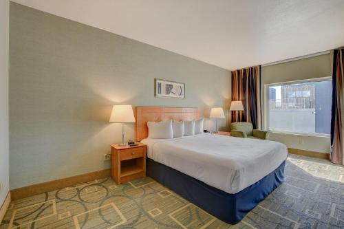 a hotel room with a bed and a window at Sky Mist Suite at Platinum Hotel in Las Vegas