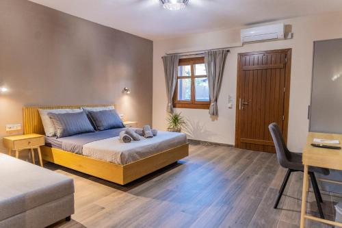 a bedroom with a bed and a desk at Meteora Living Rooms in Kastrákion