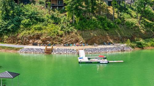 a boat sitting on the water in a lake at Lake View Serenity - Indoor Pool - Arcade - Lake in Sevierville