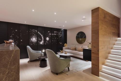 a living room with a couch and chairs at Leonora by Viadora in Mexico City