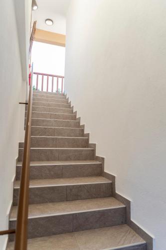 a staircase in a house with concrete steps at Meteora Living Rooms in Kastrákion