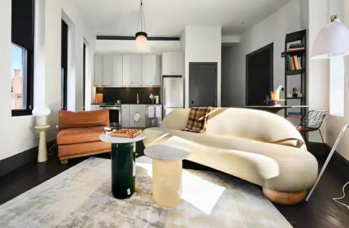 a living room with a couch and a table at Remodeled 2BR Downtown Near Acrisure Stadium in Pittsburgh