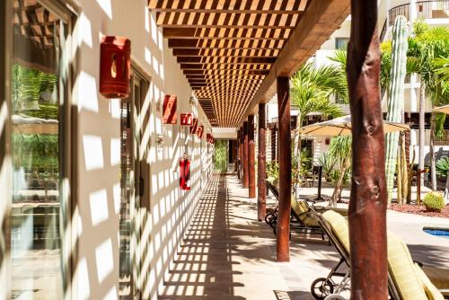 an empty hallway of a building with tables and umbrellas at Hotel Santa Fe Loreto by Villa Group in Loreto