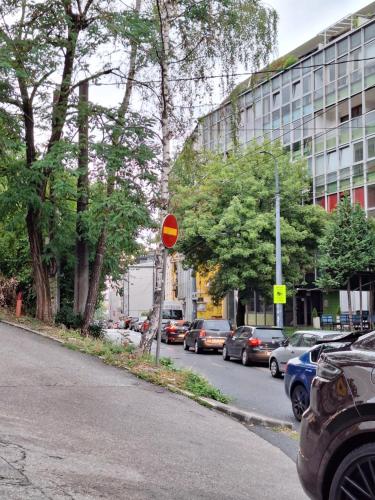 a street with cars parked on the side of the road at At Mejdan Rooms in Sarajevo