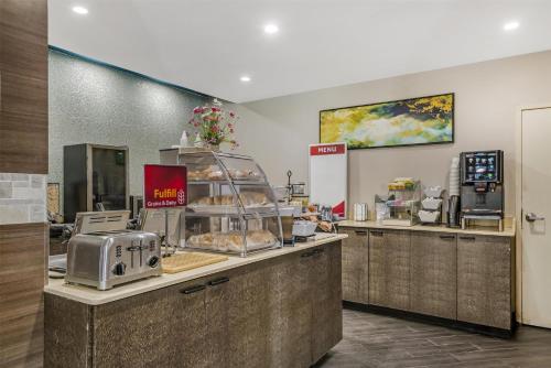 a bakery with a counter with pastries on it at Best Western Plus Sanford Airport/Lake Mary Hotel in Sanford