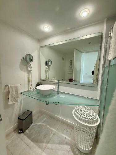 a bathroom with a sink and a large mirror at Park Royal 809 Vista al Mar in Mazatlán