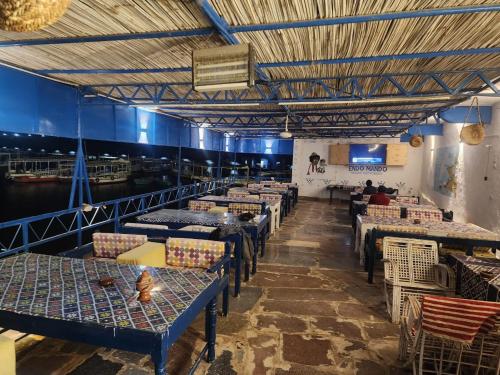 a row of tables and chairs in a restaurant at Endo Mando in Shellal
