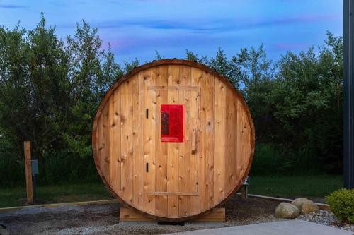 a large wooden barrel with a red door at Pleasant Valley Resort in Arcadia