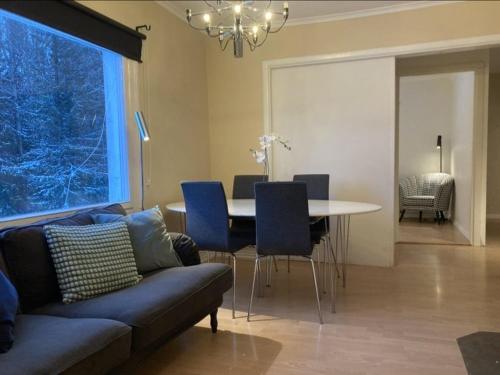 a living room with a couch and a table and chairs at 4 bedroom apartment in Kramfors in Kramfors