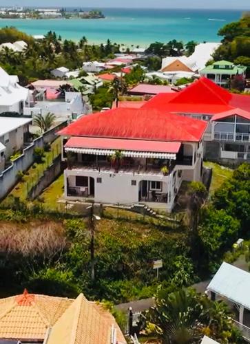 an aerial view of houses with red roofs at Chambre d'Hôtes Caïpi in Le Gosier