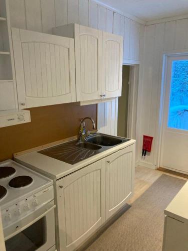 a kitchen with white cabinets and a sink at 4 bedroom apartment in Kramfors in Kramfors