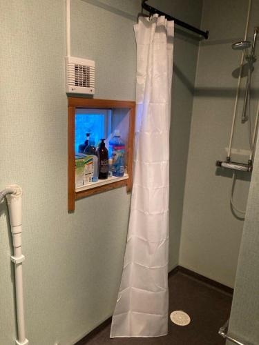 a bathroom with a shower curtain in a room at 4 bedroom apartment in Kramfors in Kramfors
