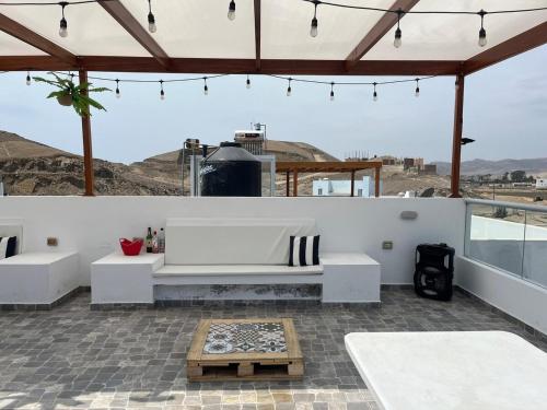 a patio with a white couch and a table at Casa de playa en cerro azul in Cerro Azul