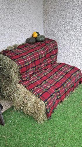 a blanket sitting on a pile of hay at Wuthering Heights in Angolo Terme