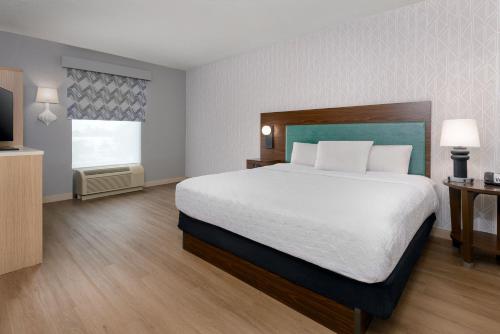 a bedroom with a large bed and a television at Home2 Suites By Hilton Nokomis in Nokomis