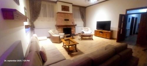 a living room with a couch and a tv at Vila na Rtnju in Rtanj