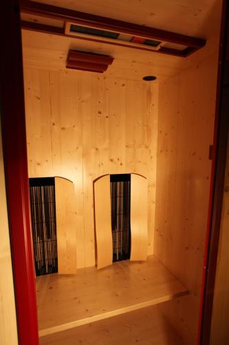 an empty room with wooden walls and a wooden floor at Haus Helga in Kappl