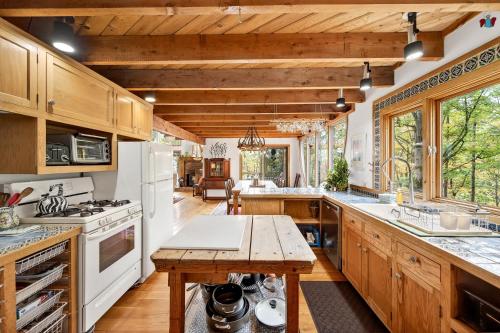 a kitchen with white appliances and wooden cabinets at Spacious 6 Bedroom Chalet Near Holiday Valley in Ellicottville