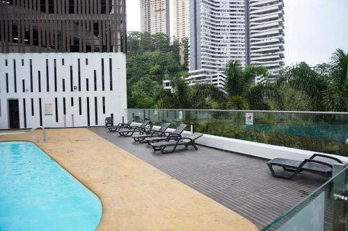a swimming pool with lounge chairs on a building at Luxurious apartment in Las Palmas in Medellín