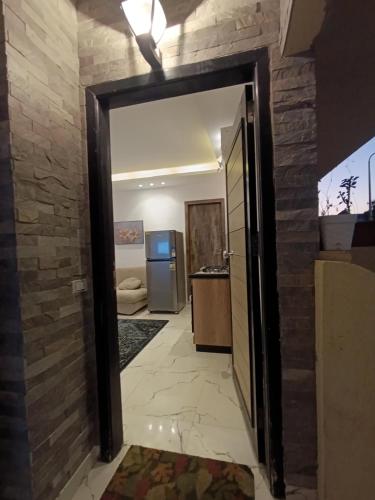 an open door to a room with a kitchen at studio in villa in Asyut